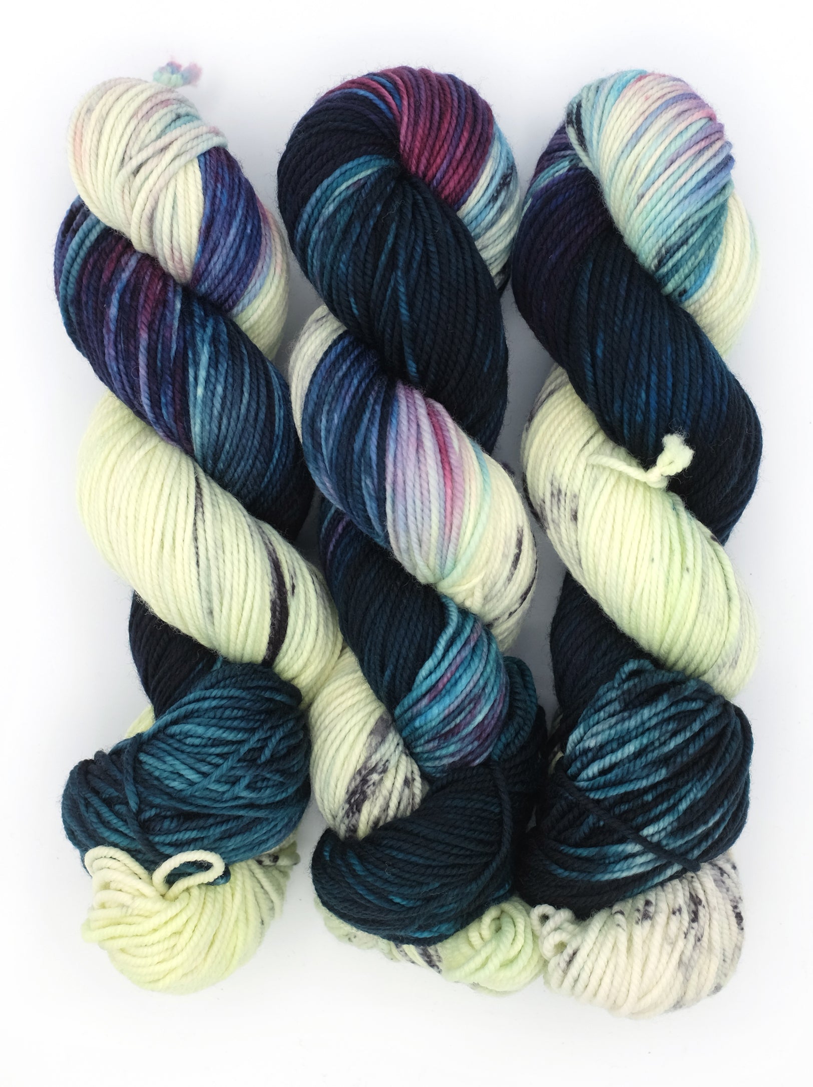 Set of multicolored yarn skeins on a white background