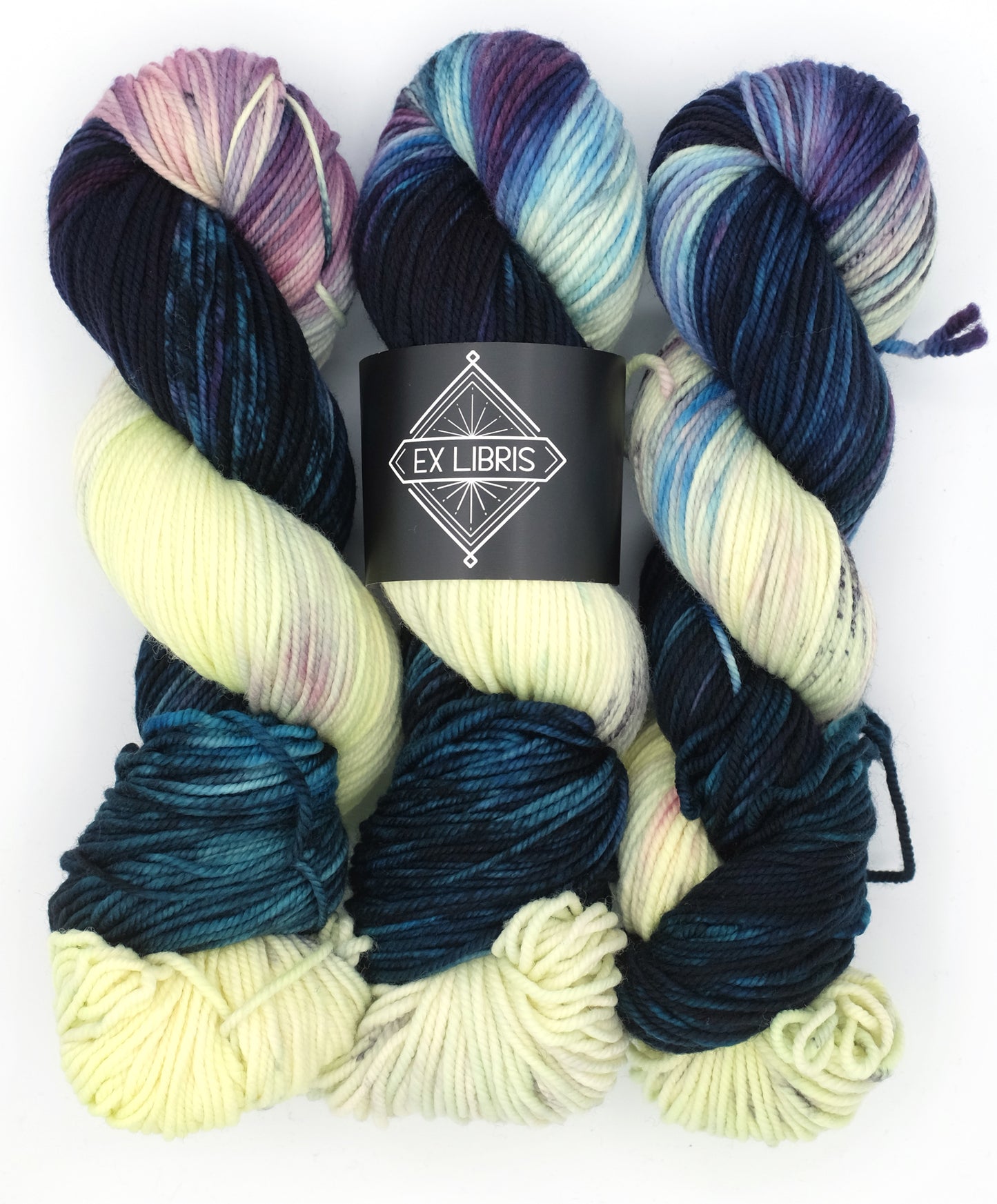 Three skeins of multicolored yarn with a 'Ey Libris' label on a white background
