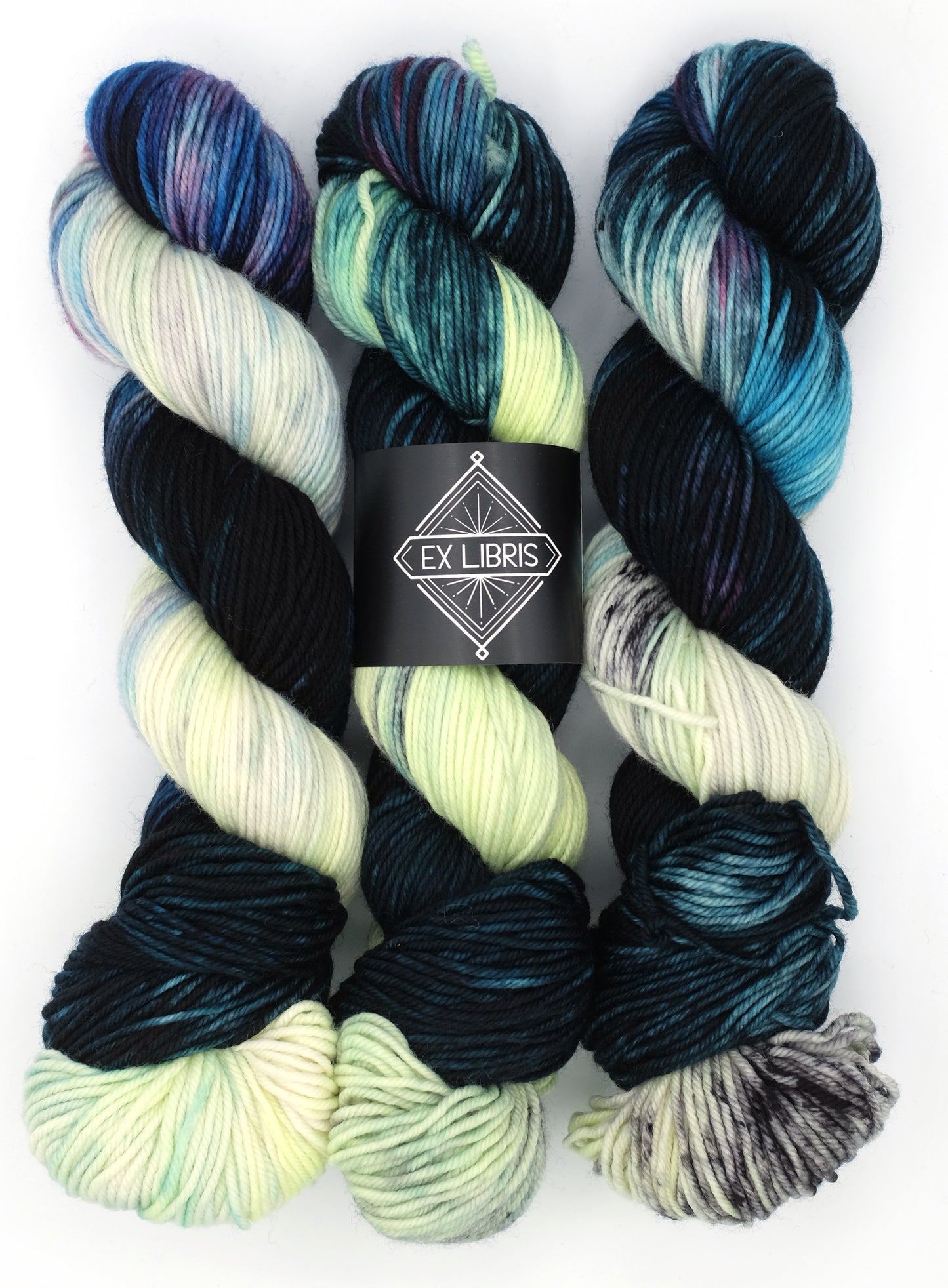 Three skeins of multicolored yarn with a 'Ex Libris' label on a white background