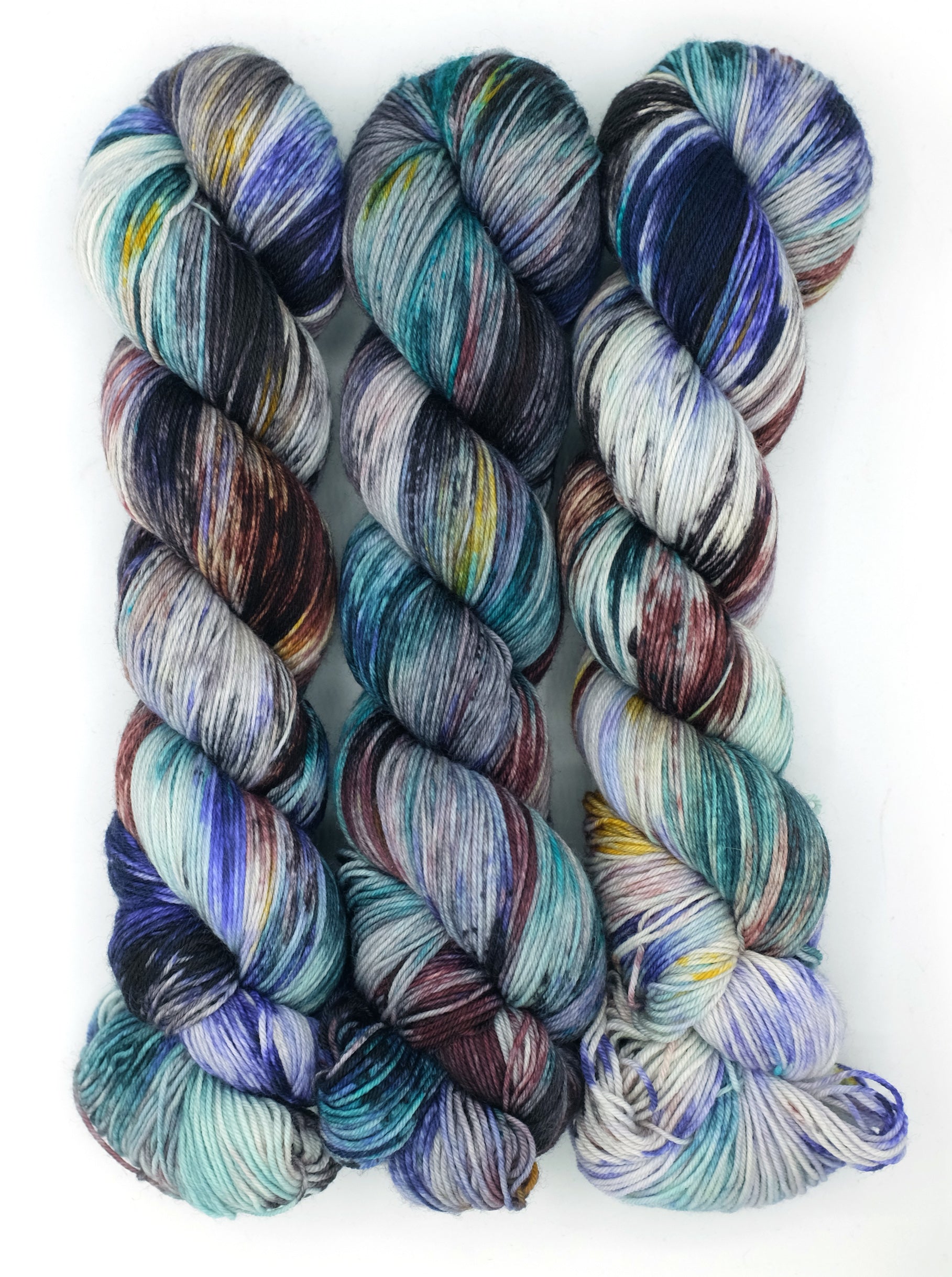 Set of multicolored yarn skeins on a white background